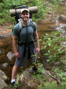 Photo of Kelsey hiking along a river